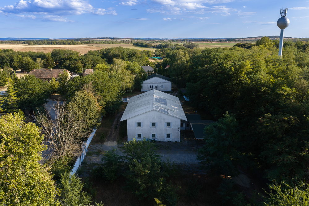 The guesthouse compound from the air, the Gerecse Hills beyond