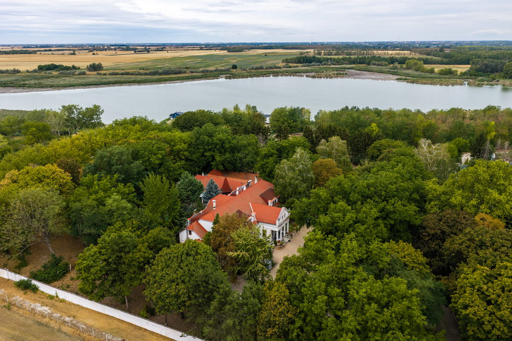 The walled precinct within its trees, the lakes beyond