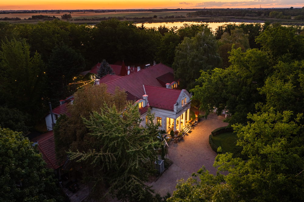 The manor at dusk, from above the parkland
