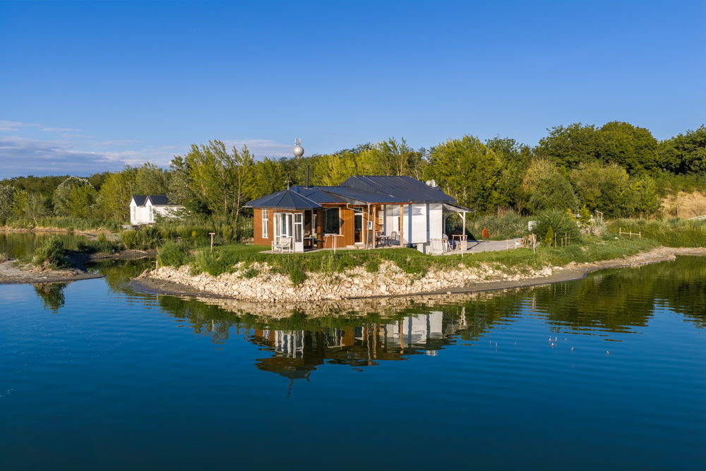 A lakeside pavilion on its stone promontory